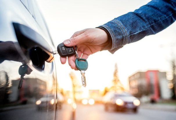 woman opening her car with a key